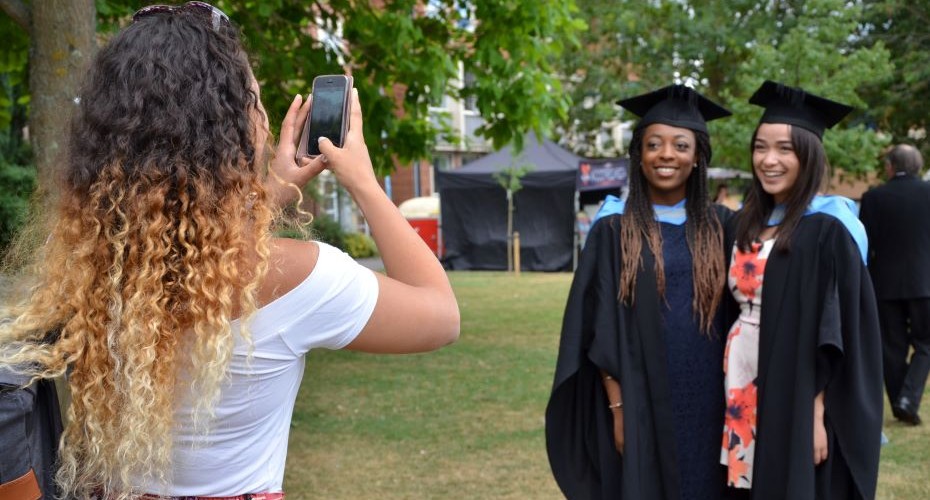 Medical students taking photos of each other at graduation