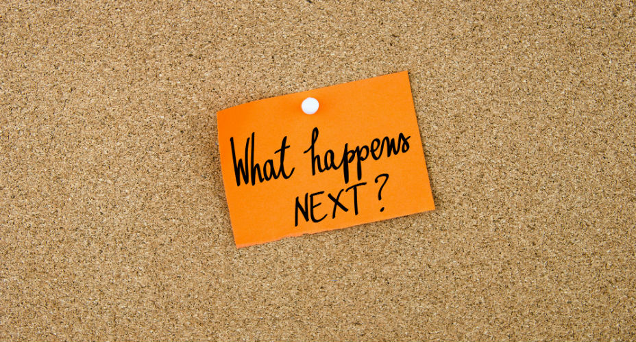What happens next - post-it note pinned on a cork board