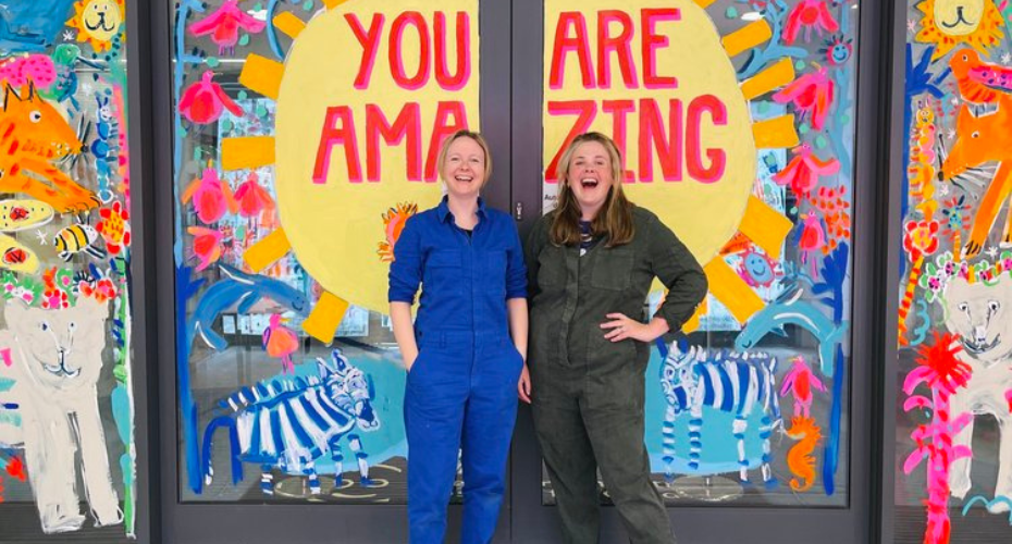 Sarah Moore and artist Emily Powell painting the front entrance of Great Ormond Street Hospital