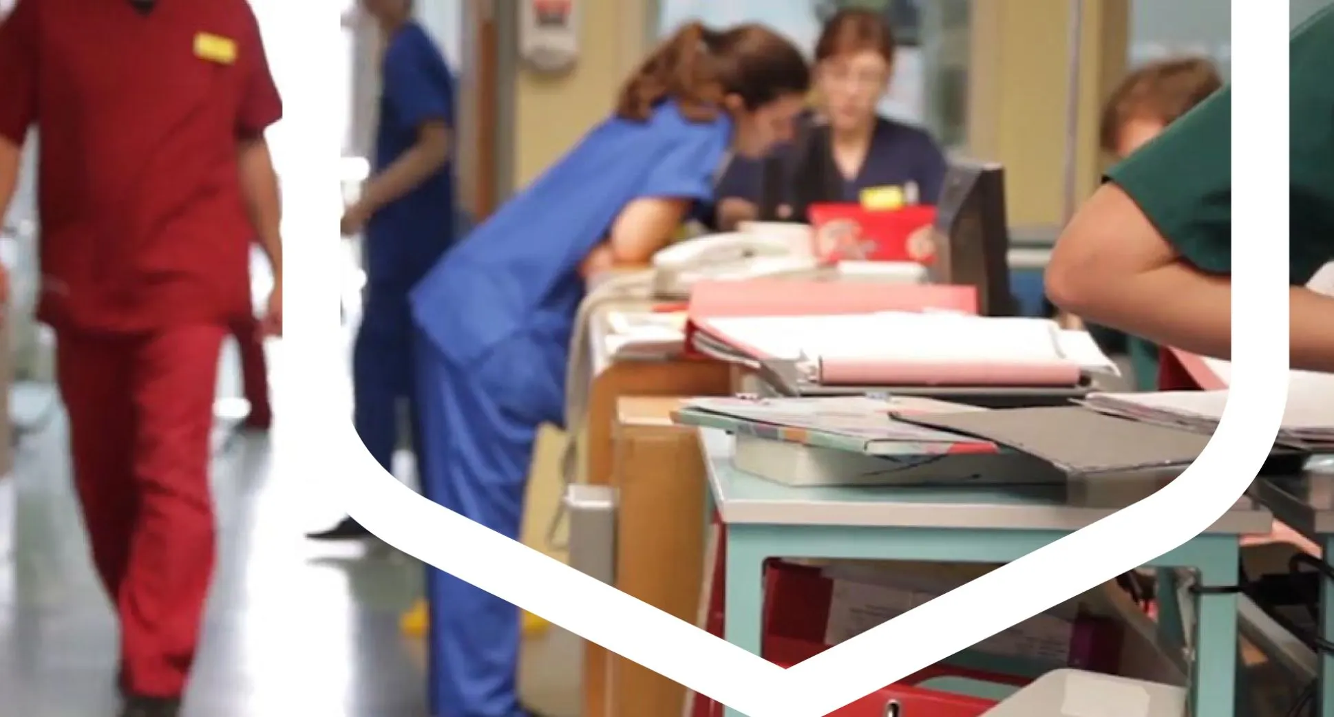 A group of healthcare professionals in scrubs collaborating in a hospital setting.
