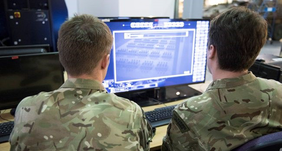 Seen from behind, two army officers looking at AR training on a screen