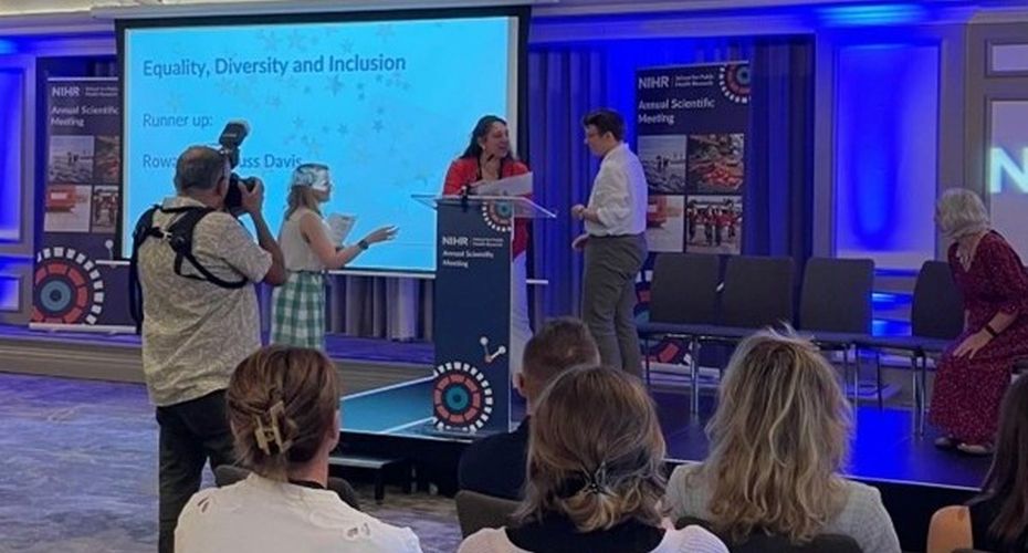 A person receiving an award in front of an audience