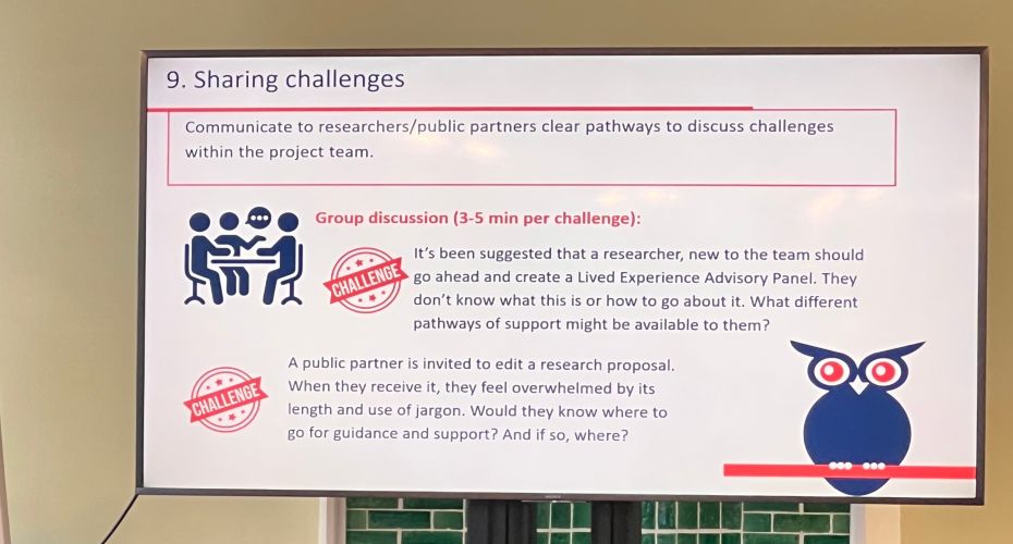 A large screen with writing and diagrams on