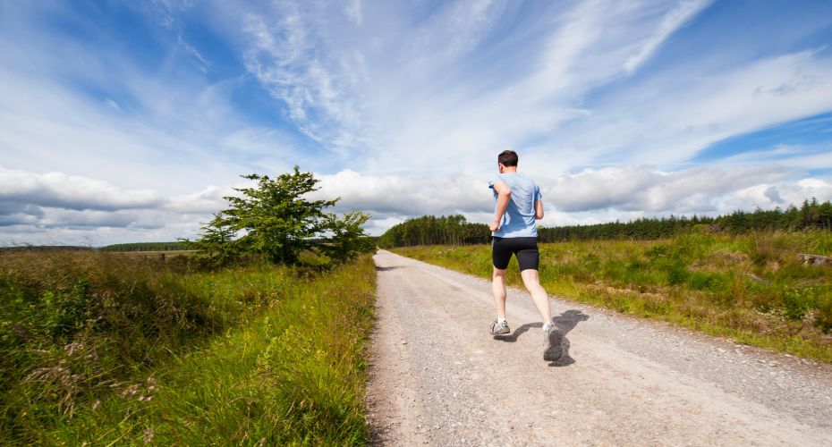 Man jogging along path in countryside
