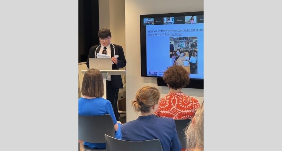 A young person standing at a podium giving a presentation