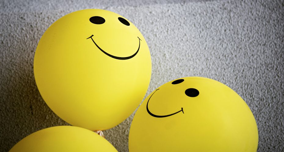Yellow smiley face balloons