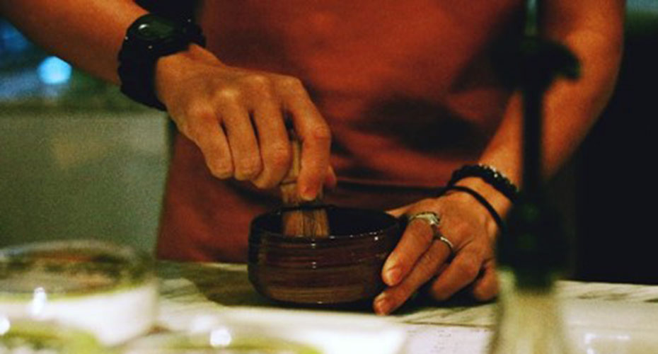 Close up on hands using a pestle and mortar