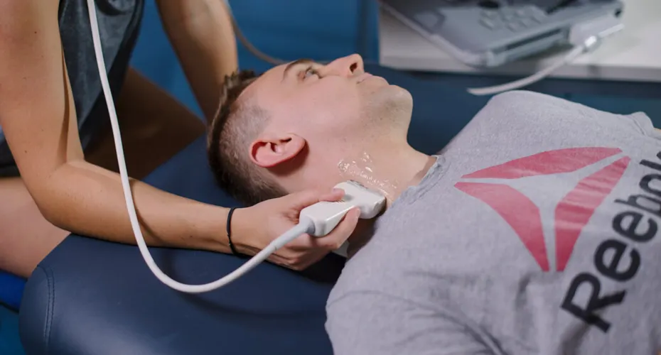 A Sports and Health Sciences student conducting an ultrasound scan of someone's neck.